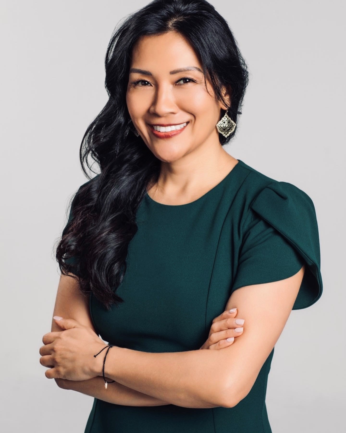 Photo of woman in dress with arms crossed