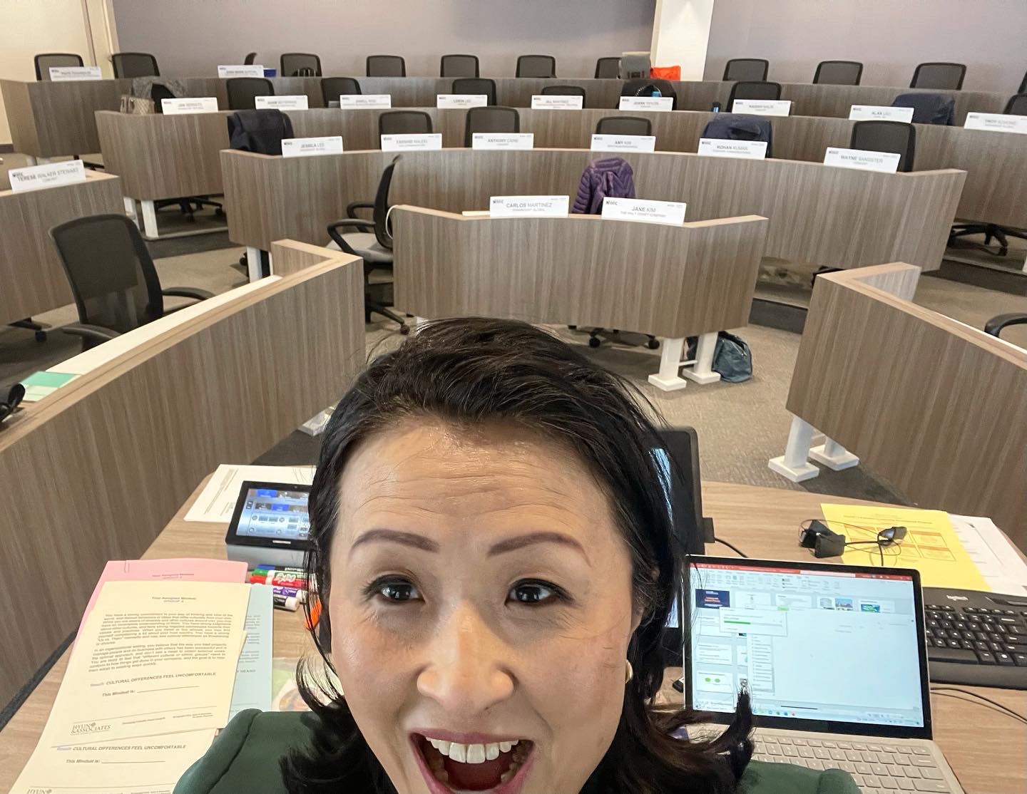 Woman in foreground with empty desks behind